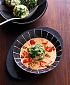 Spinach dumplings in tomato sauce on plate