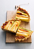 Pieces of quiche on chopping board