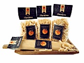 Various types of pasta on wooden board