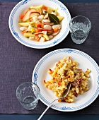 Macaroni pasta and beans with apple slices on plates