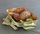 Loin of pork with apples in serving dish