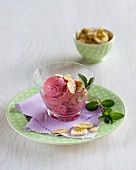 Banana and blackcurrant ice cream in bowl on plate