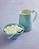 Milk in blue polka dot jug and cream in blue bowl