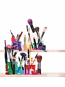 Variety of make-up brushes and concealer on shelf