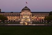 Facade of illuminated Kurhaus and fountain at Wiesbaden, Hesse, Germany