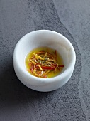 Oranges and chilli butter in bowl