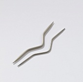 Close-up of two cable needles on white background