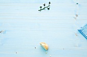 Piece of bread and tomato stem on blue background