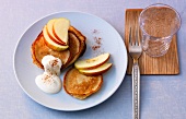Pancakes with apple and cinnamon on plate