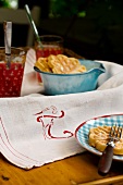 Wafers in bowl and plate on white cloth with monogram