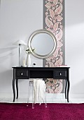Black dressing table against wallpaper with paisley pattern