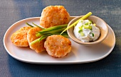 Shrimp cakes with lime dip on plate