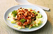 Spicy Asian salad with chicken breast and vegetable on plate