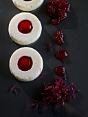 Yogurt ring with strawberry puree on black platform