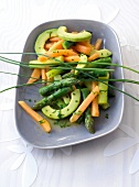Asparagus salad with melon and avocado on plate