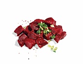 Goulash with green onions on white background