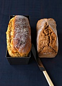 Spelt bread besides potato bread in baking tin