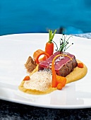 Slice of beef with potato and carrot on plate by Ivo Adam