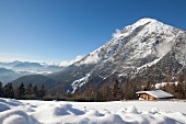 View of snow capped mountain and hut on winter landscape, Leutaschtal, Tirol , Austria