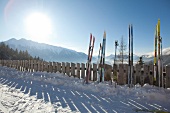 Skis leaning on fence in snow , Leutaschal, North Tyrol, Austria