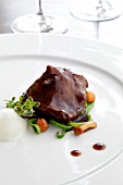 Veal cheeks with chanterelles and merlot Sauce on plate