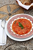 Tomato soup with herb in bowl