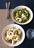 Colourful cheese salad and asparagus with fennel salad in bowls