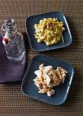 Two plates of turkey salad with curry and chicken salad with hot peppers