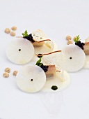 Poached veal breast with eels, beer radish cream and caviar on white background