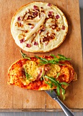 Pancake with asparagus and oval pizza on wooden board