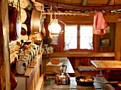 Earthenware kettles on shelf in country kitchen