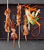 Close-up of pork skewers in marshala on tray