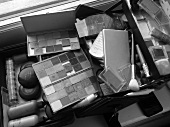 Close-up of various cosmetic palettes and brushes , black and white