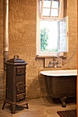 Old fashioned bathroom with, stove, sink and bathtub