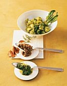 Bowl of pesto orecchiette with other dishes