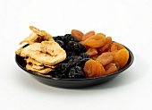 Dried fruits in plate on white background