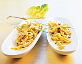 Spaetzle pasta with cheese and shallots in serving dishes