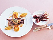 Polenta with radicchio and quail chops on plates