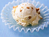 Close-up of ice-cream with pieces of biscuits on glass plate