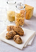Gluten free bread crumbs in jars and bread and millet rolls on folded napkin