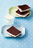 Baked dairy cream cakes in serving dish on blue background