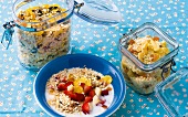 Three different kinds of cereal for infants in bowl and glass jars