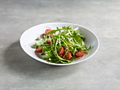 Arugula salad with cherry tomatoes in bowl