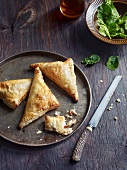 Close-up of puff pastry bag on plate with knife