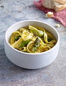 Tagliatelle with green asparagus in bowl