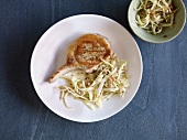 Chop with coleslaw on plate, overhead view