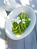 Wild green asparagus with peas in bowl