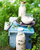 Lemon yogurt dressing and fresh goat cheese dressing on stool in garden