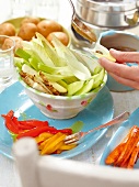 Close-up of hand filling hot anchovy and garlic sauce in vegetables