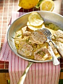 Close-up of lemon schnitzel in pan